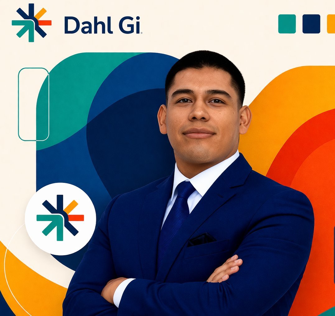 Professional man in dark blue suit with arms crossed, Dahl Gi branding with teal, navy, orange and red geometric shapes